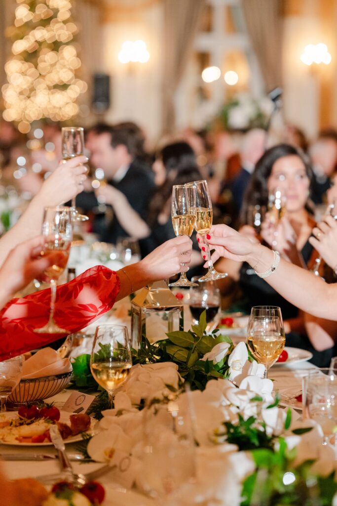 guest cheers at reception, champagne toast at elegant wedding reception