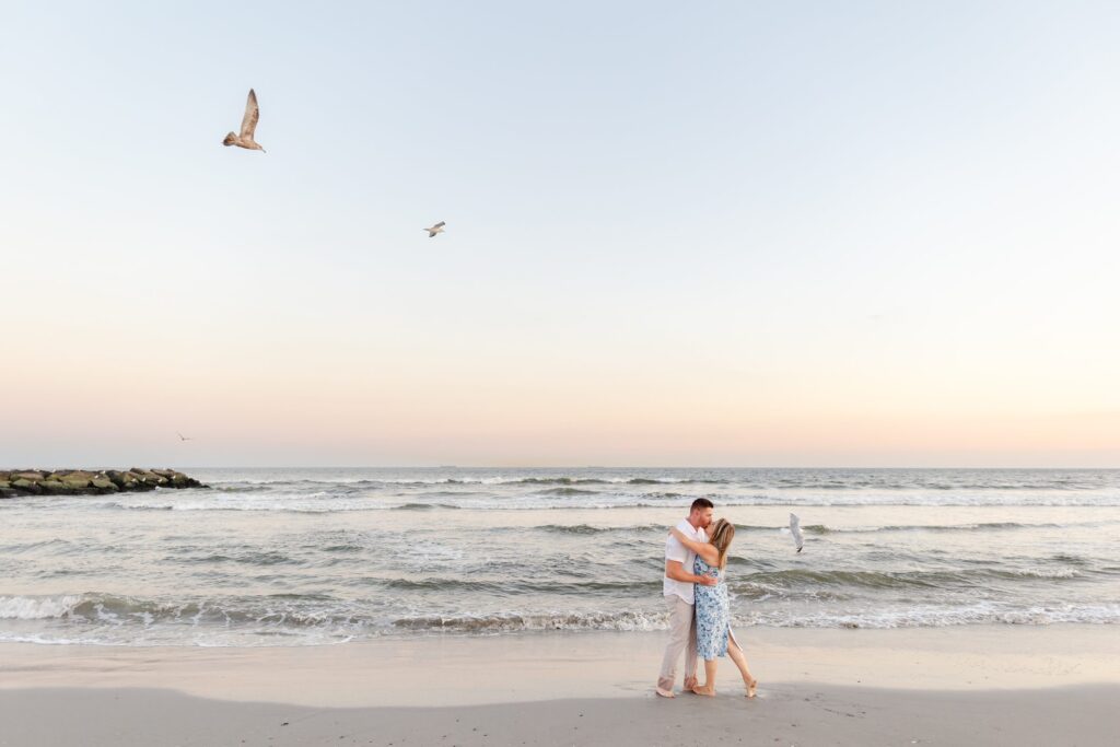 engaged couple walking on the beach, beach engagement session in Long Beach, NY