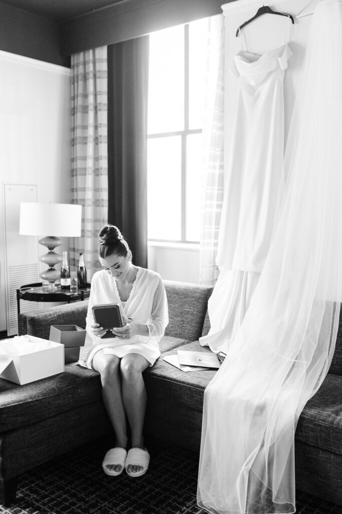 bride getting ready, love letter from groom, wedding dress