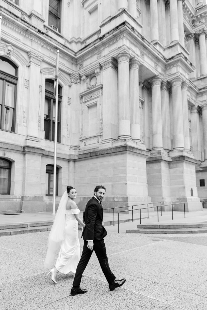 bride and groom walking in downtown Philadelphia, wedding veil, bride and groom portraits, downtown Philadelphia