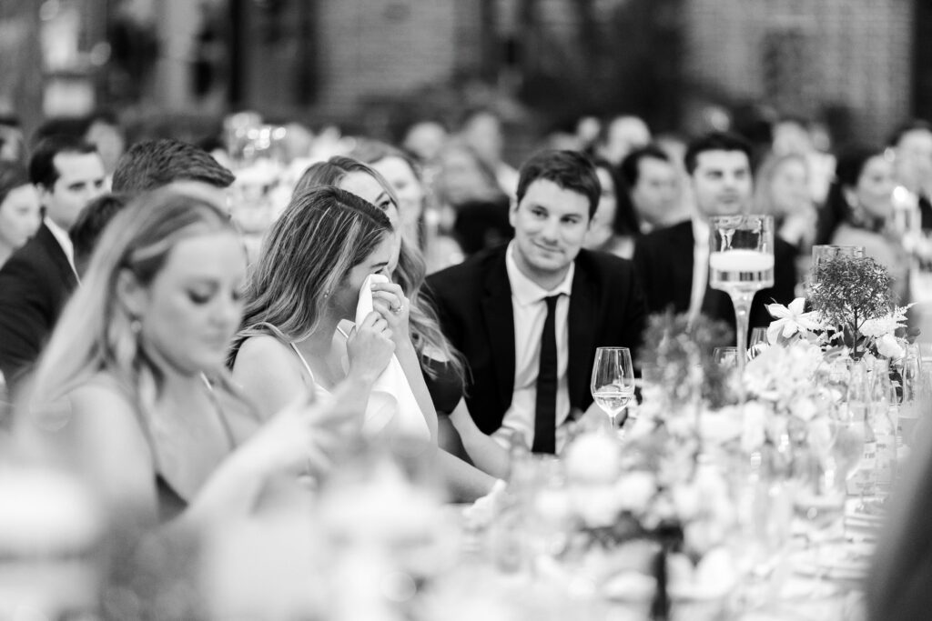 bride crying during wedding speech seating chart importance, family laughing at wedding speech