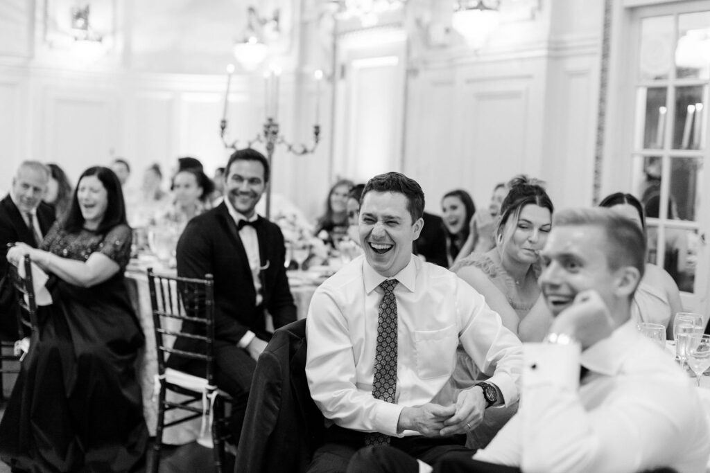 guests laughing at the wedding speeches