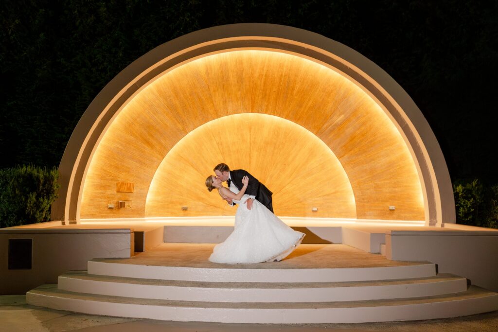 bandshell night portraits, bride and groom kissing night portraits