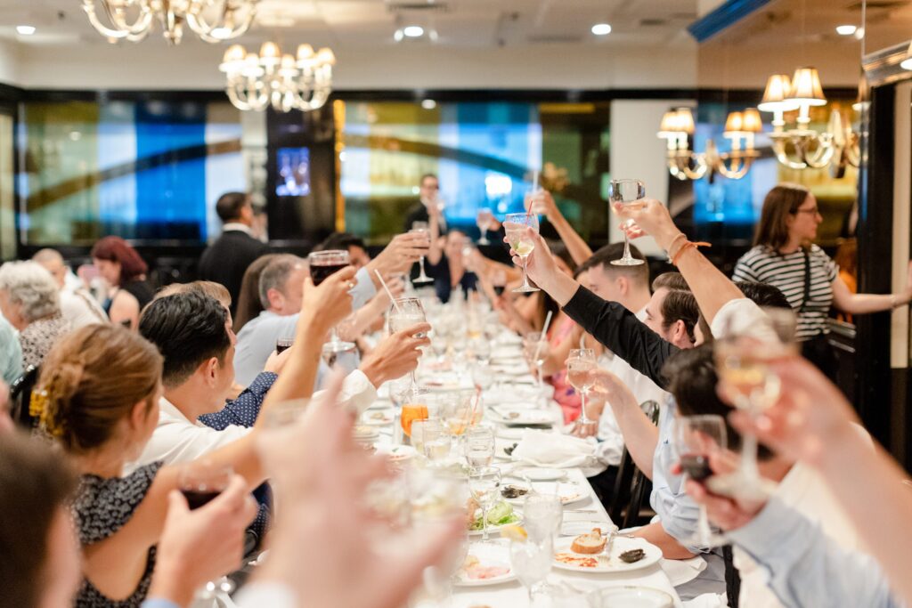 Rehearsal Dinner at Arno, table cheers to the bride and groom 