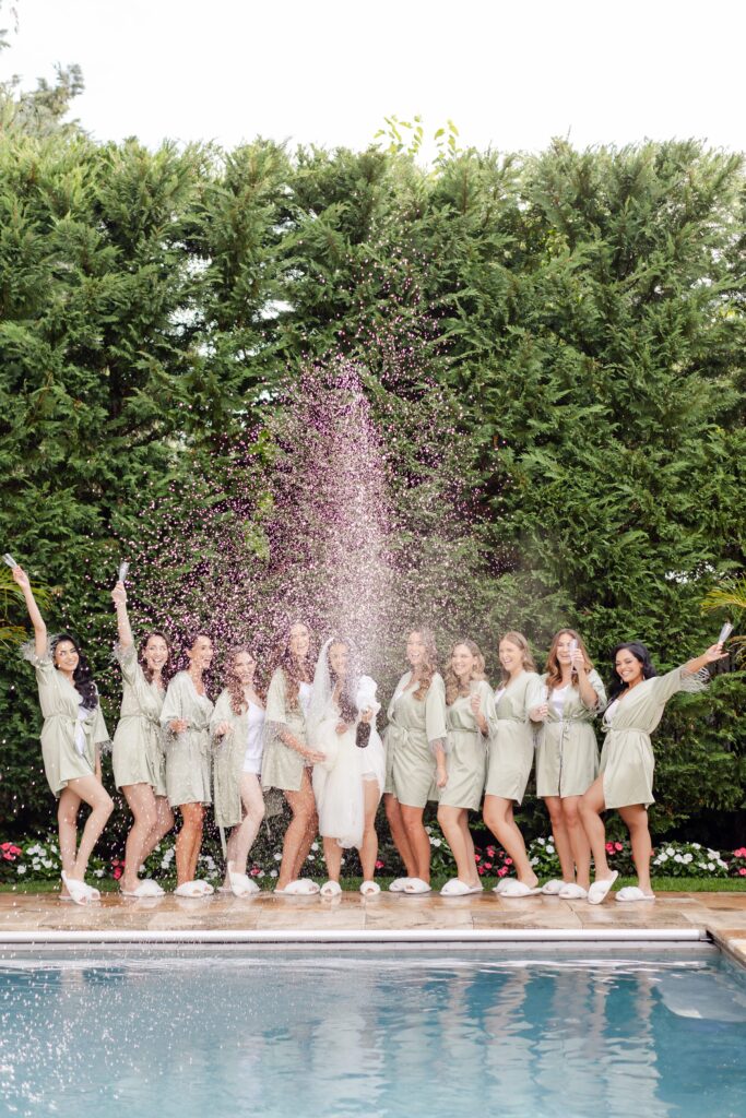 bride and bridesmaids getting ready and popping champagne 