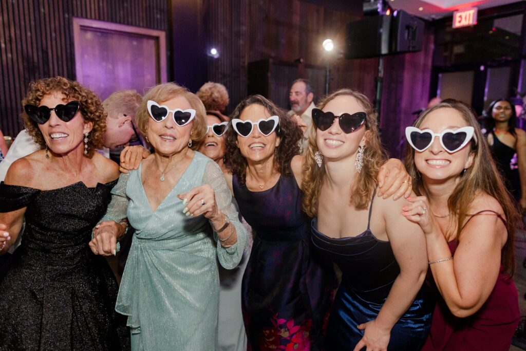 heart-shaped glasses on wedding guest during reception