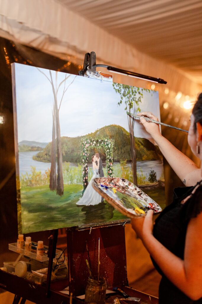 live painter painting the ceremony at the reception 