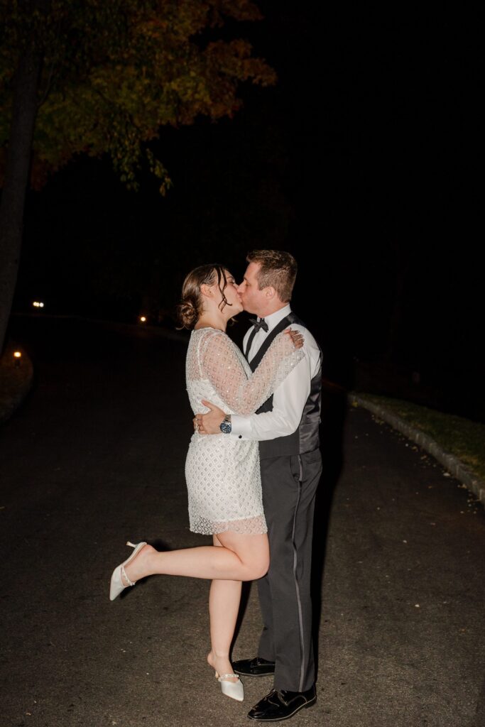 bride and groom kissing during send off