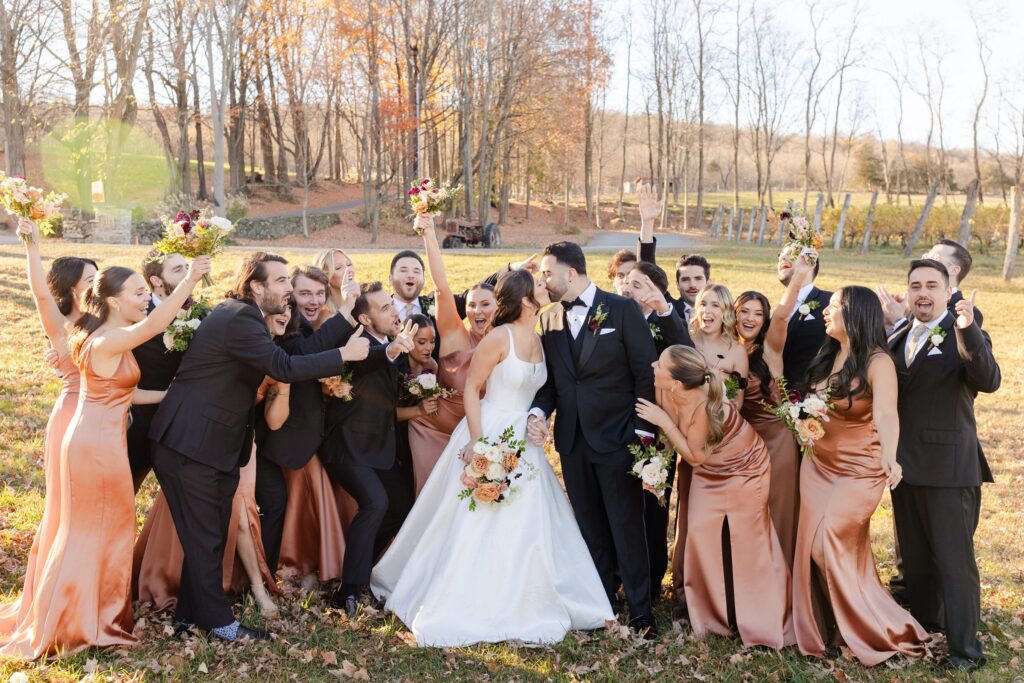 bride and groom kissing in front of bridal party, Outdoor ceremony at Red Maple Vineyard, New York Vineyards venue inspiration, Red Maple Vineyard ceremony 