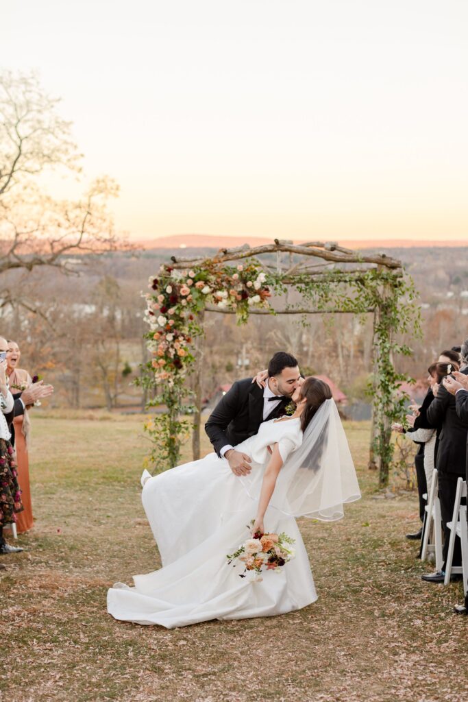 New York Vineyard Wedding Inspiration, just married kiss with bride and groom at Red Maple Vineyard