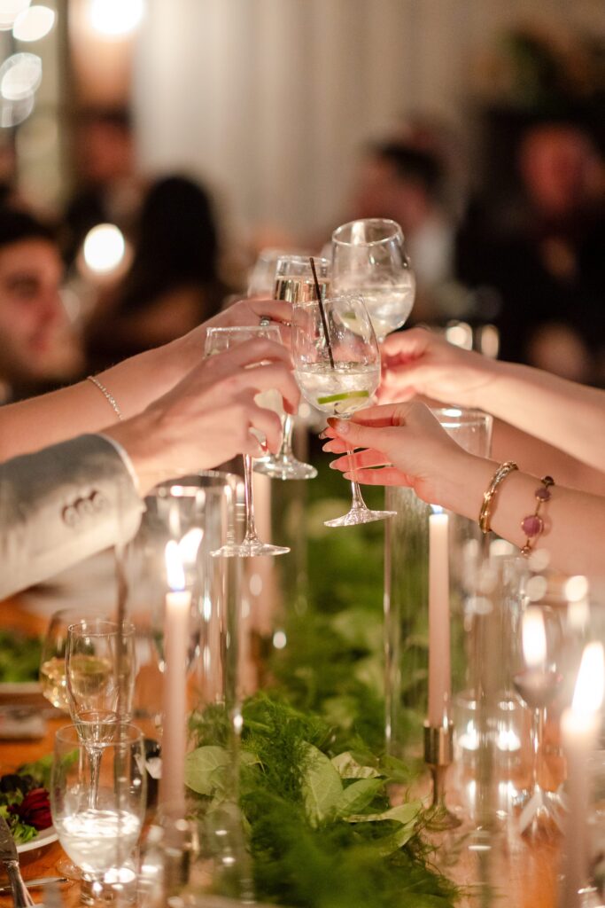 guest cheers with glasses at wedding reception, Red Maple Vineyards wedding reception