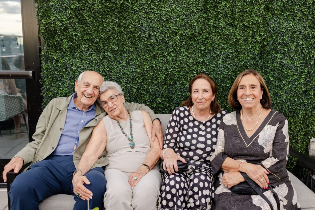 guests smiling at rooftop Welcome Party