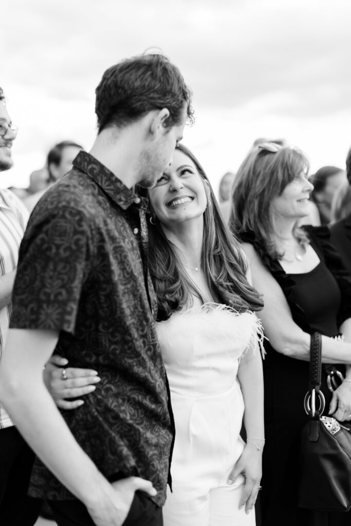 bride and groom smiling during speeches