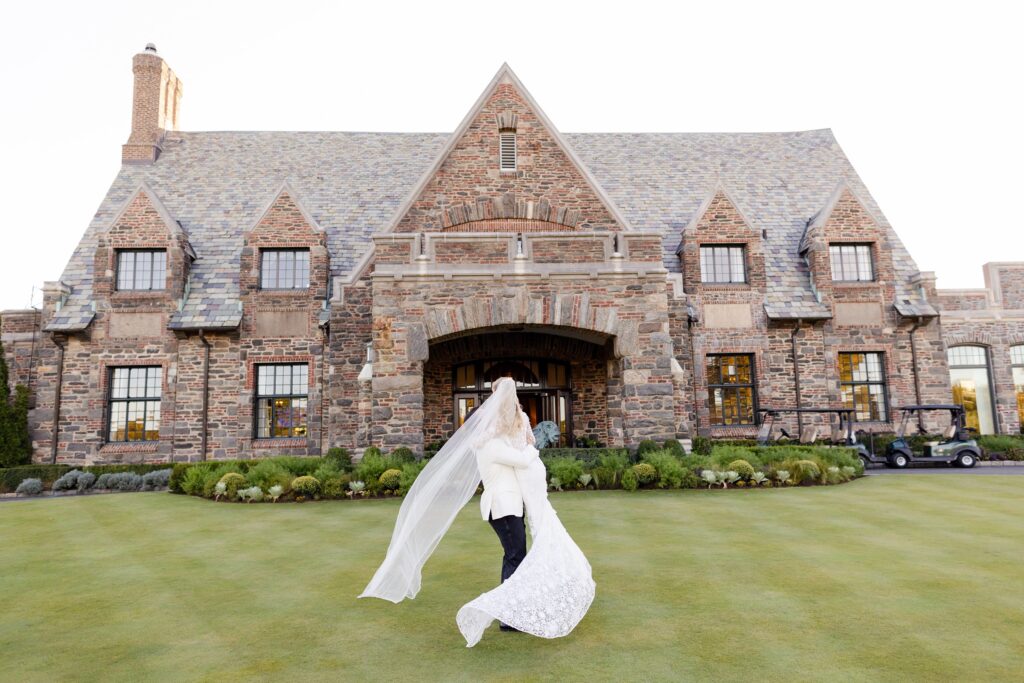 bride and groom twirling at Winged Foot Golf Club, New York golf cub wedding 