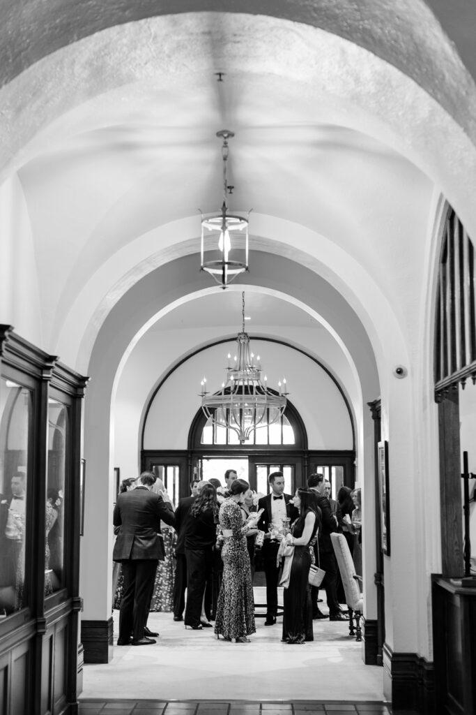 cocktail hour at Winged Foot Golf Club in the bar lounge, Winged Foot Golf Club Wedding, guests mingling in the foyer with drinks 