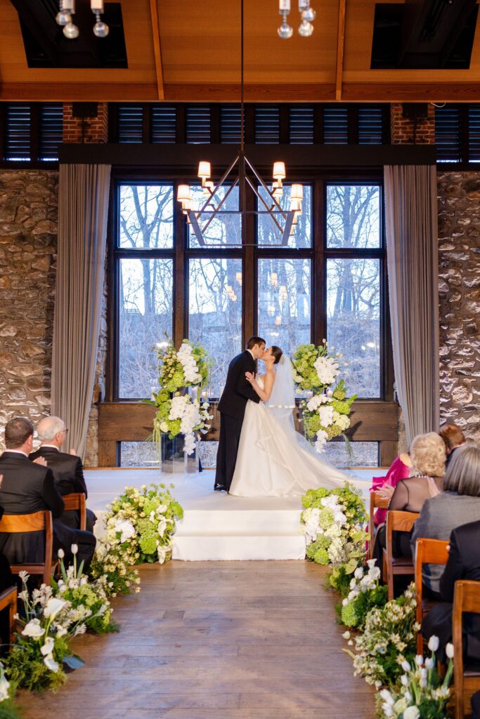 newlywed first kiss durign wedding ceremony