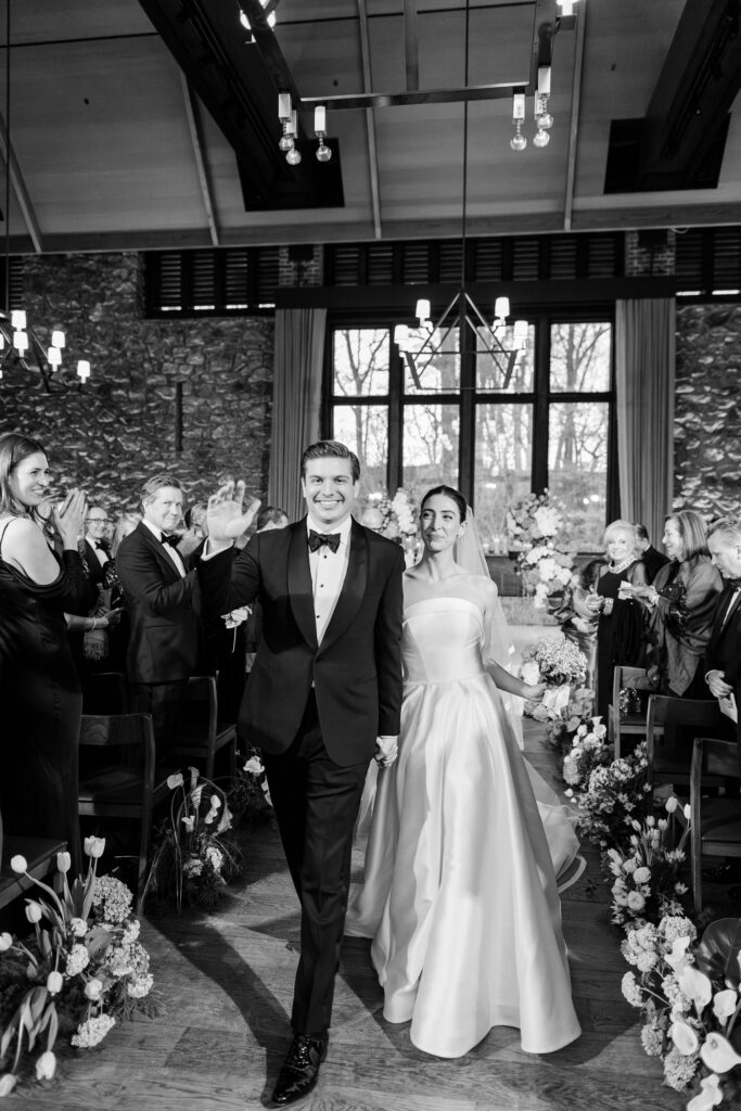 bride and groom just married walking down the aisle