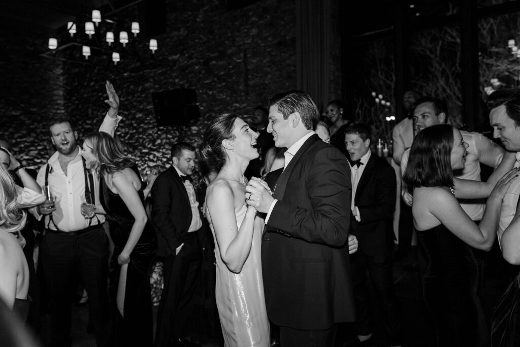 bride and groom dancing and singing on the dancefloor during the reception