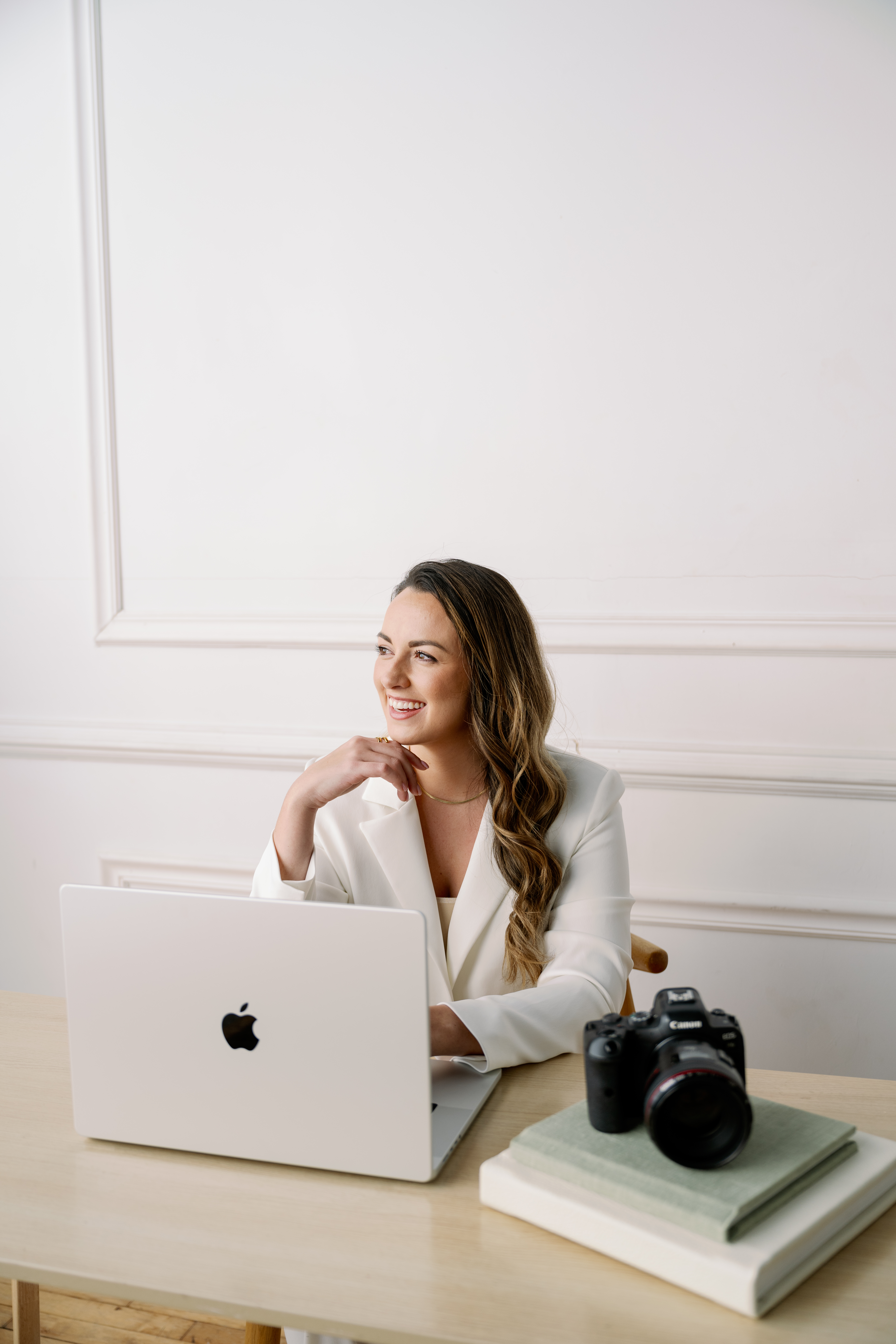 photographer posing with camera at desk