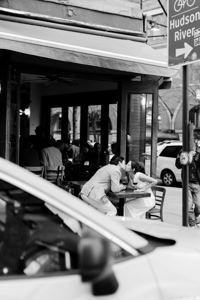couple kissing at the table by Hudson Hound, top West Village engagement locations, engagement session at west village