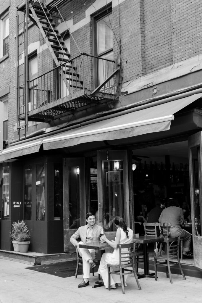 couple laughing at the table by Hudson Hound, top West Village engagement locations, engagement session at west village