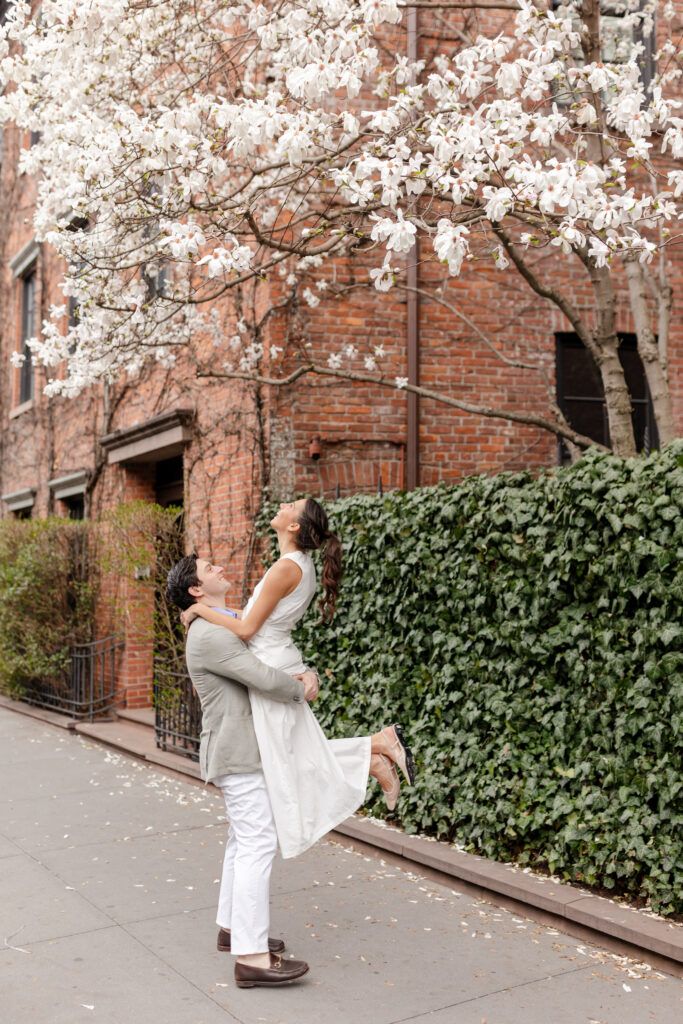 couple dancing in the street under spring blooms in West Village, top West Village engagement locations
