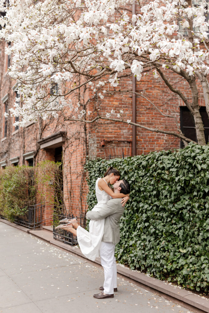 couple dancing in the street under spring blooms in West Village, top West Village engagement locations