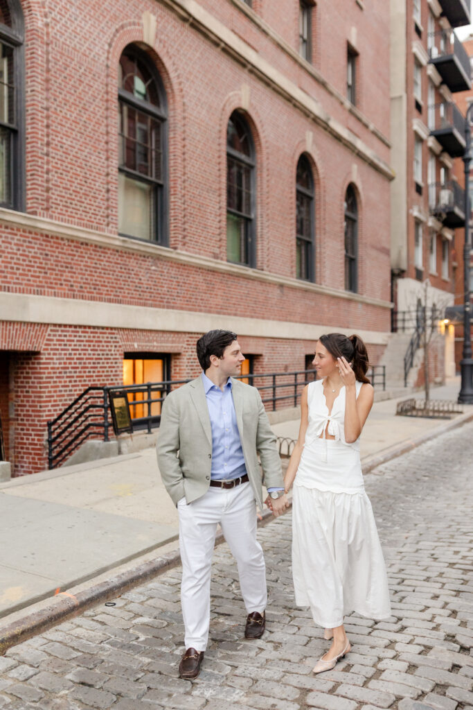 couple walking down the street during engagement session at West Village, top West Village engagement locations
