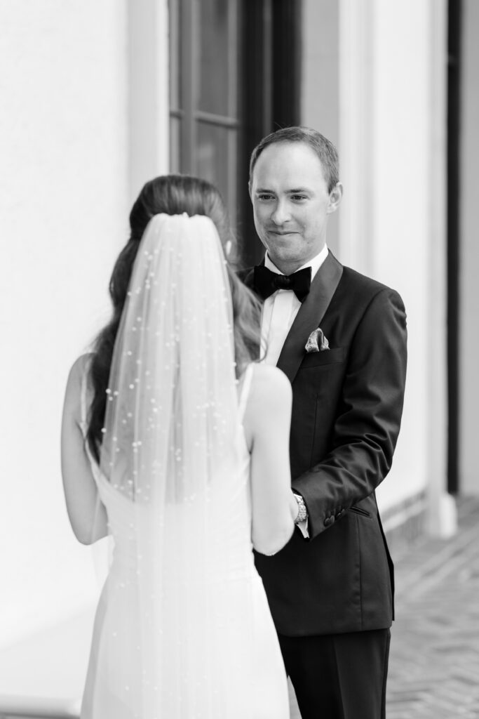 groom shedding a tear during first look with bride out front of Westchester Country Club