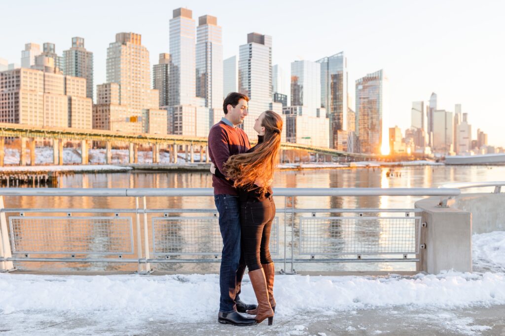 couple dancing in the sunset on the snowy Pier 1 with NYC in the background