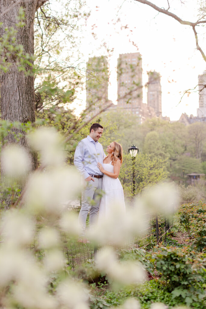 couple embracing in Central Park during sunset for their NYC engagement session