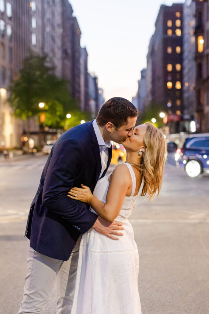 couple kissing at sunset with the New York City streets lining the backdrop behind them, NYC Engagement Locations