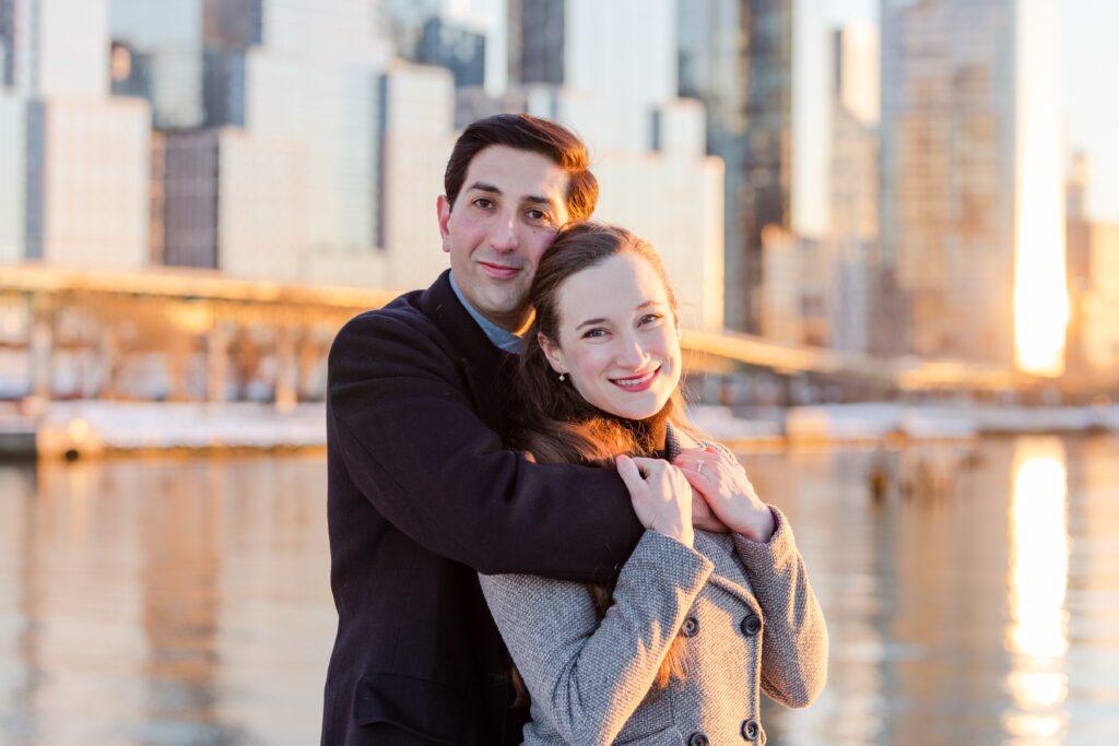 couple embracing and smiling at the camera on Pier 1 at sunset