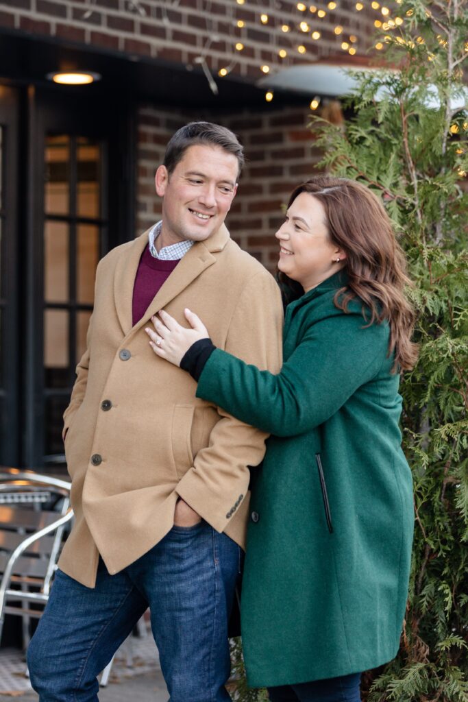couple embracing on the sidewalk in NYC during winter engagement session