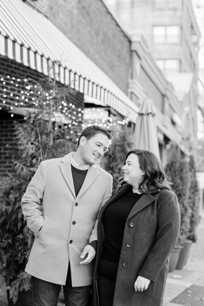 black and white photos of couple laughing during winter engagement session in New York