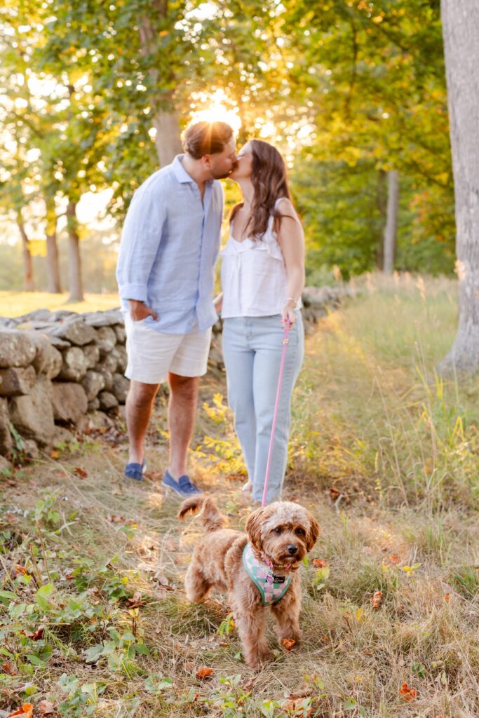 couple kissing while holding their dog's leash at Rockefeller Stat Park Preserve
