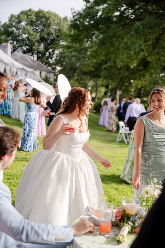 second wedding photographer example of how to capture guest during the cocktail hour, bride laughing with guests 